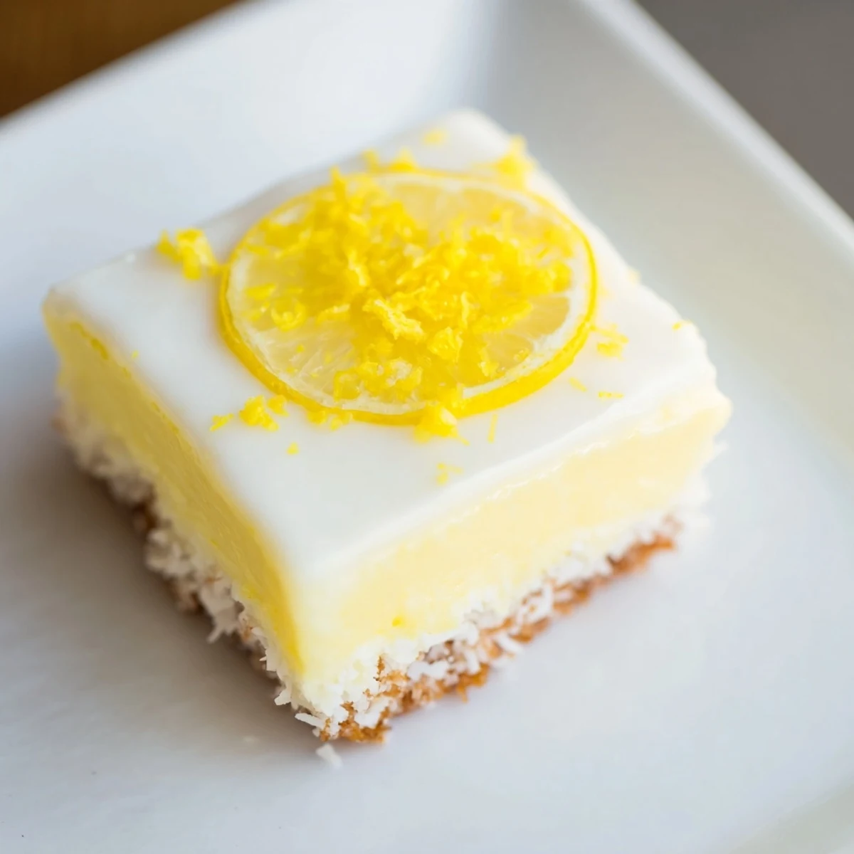 A perfectly chilled Lemon Slice, showcasing its buttery biscuit base and bright lemon icing.