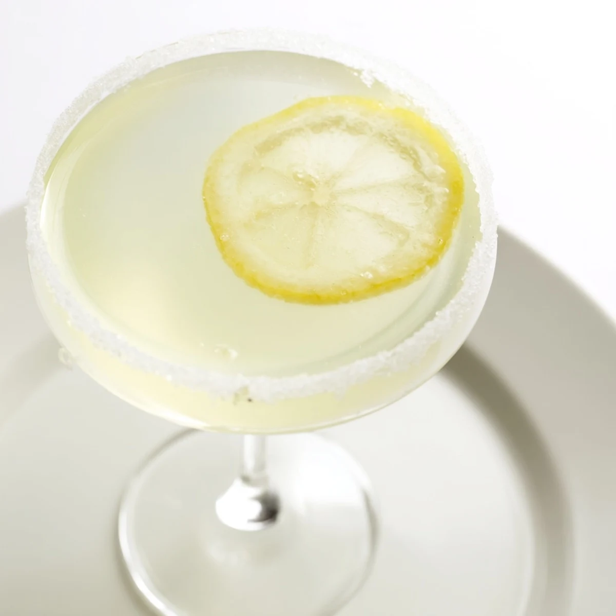 An elegant martini glass holds a classic Lemon Drop cocktail, freshly made and ready to enjoy.