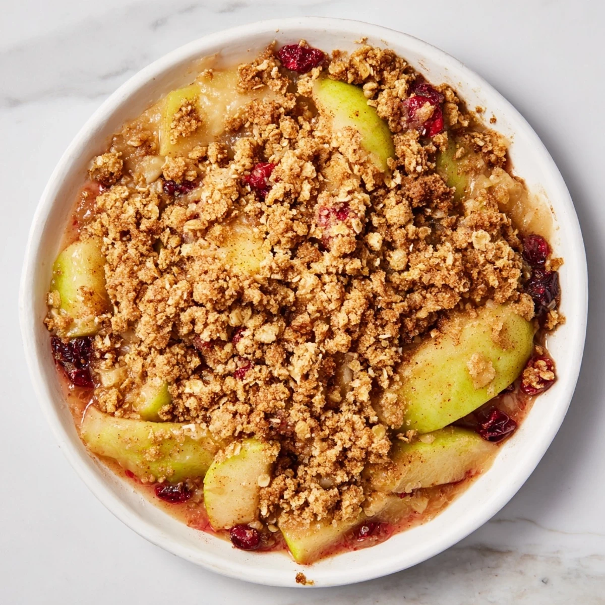 Golden, bubbly Cranberry Apple Crisp fresh from the oven, ready for serving with ice cream.