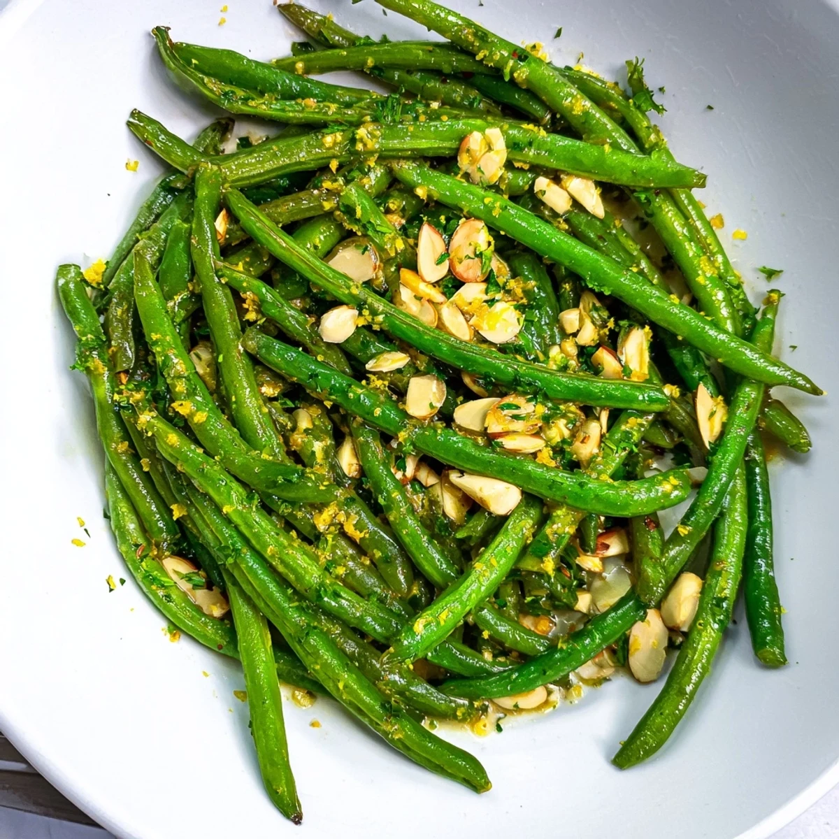 Bright green Lemon Garlic Green Beans, a zesty, flavorful side, cooked and glistening on a platter.