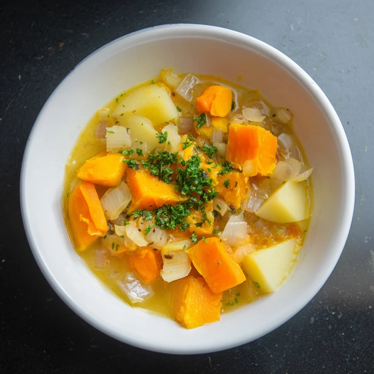 Steaming bowl of Winter Solstice Soup, filled with colorful root vegetables, ready to serve.