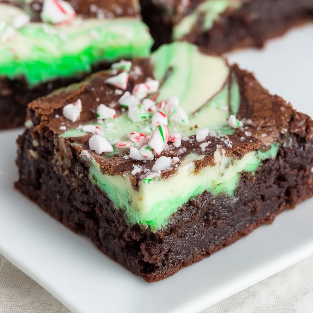 Enjoy these homemade Peppermint Swirl Brownies, cut into squares, a delightful chocolate peppermint dessert.