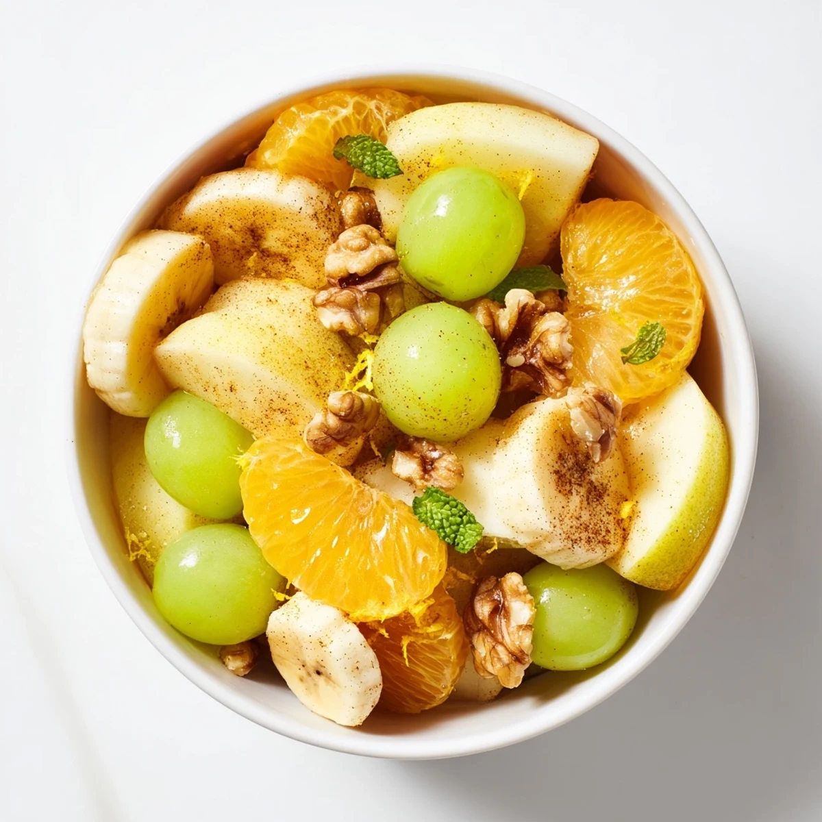 Golden-brown warm fruit salad, fragrant with cinnamon, being served in a bowl.