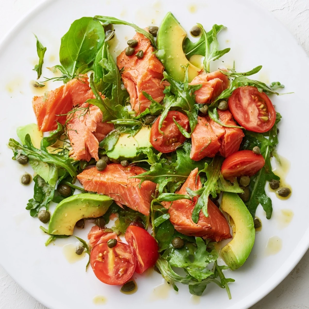 Warm Baked Salmon Lunch Salad featuring tender baked fillet over mixed greens with cherry tomatoes, avocado, and zesty lemon-dill dressing.