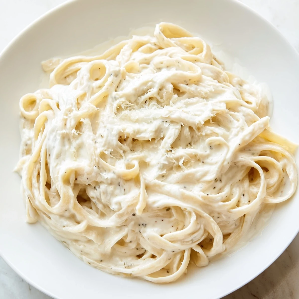Golden butter and cream blend in this Creamy Alfredo Sauce, perfect for fettuccine. 