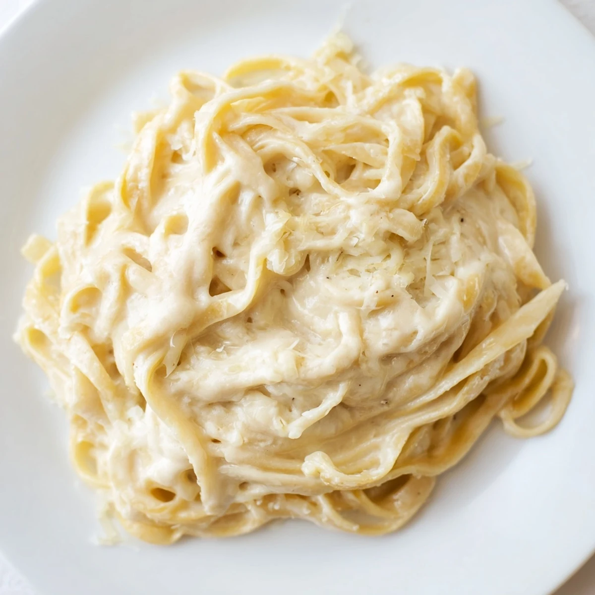 Freshly grated Parmesan stirred into velvety Creamy Alfredo Sauce, ideal for dinner.