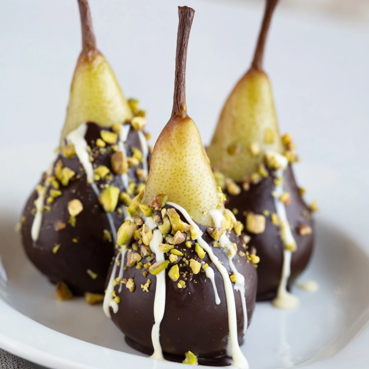 Elegant Romantic Chocolate Covered Pears drizzled with white chocolate, served chilled with a glass of sparkling wine.